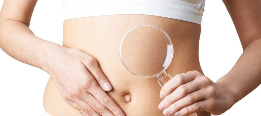 Close Up Of Woman Wearing Underwear Holding Magnifying Glass And Close Up Of Woman Wearing Underwear Holding Magnifying Glass And Touching Stomach