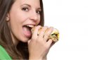 woman eating cheeseburger