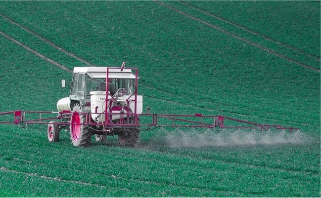 Spraying of pesticides on a field.