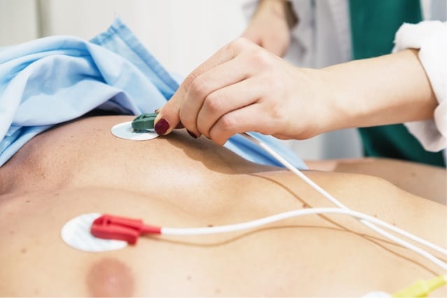 ECG electrodes placed on patient's chest.
