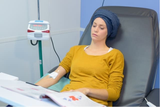 Young woman receiving chemotherapy.