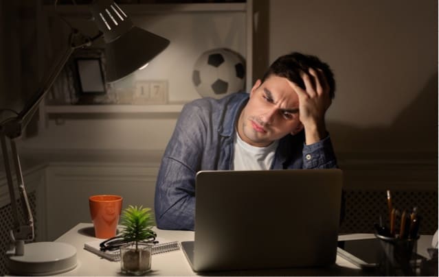 Man sitting in front of computer at night.