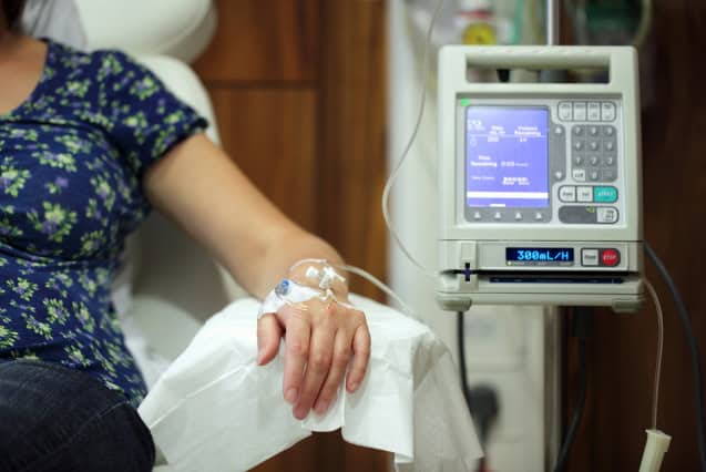 Woman receiving intravenous therapy.