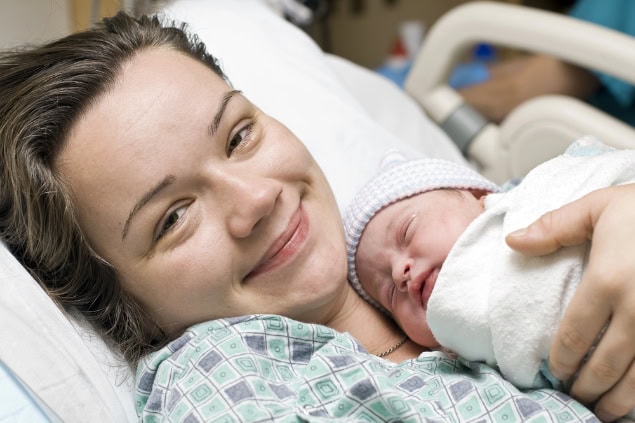 Happy mother with newborn baby.