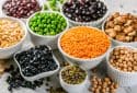 Selection of legumes in white bowls.