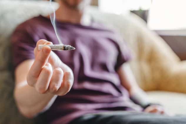 Young man smoking marijuana.