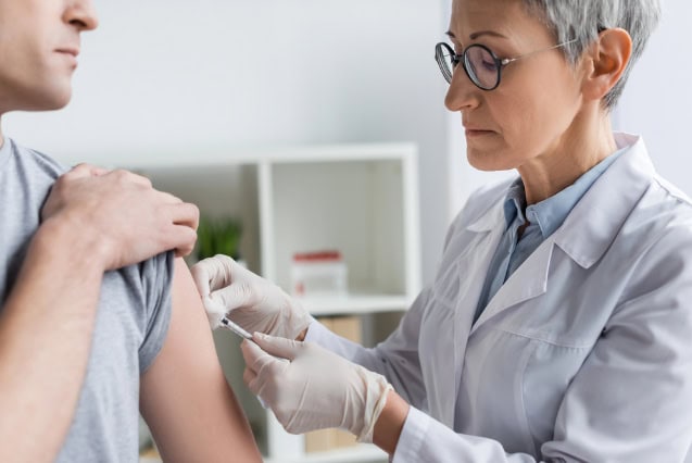 Female doctor vaccinating a patient.