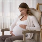Pregnant woman sitting on a chair.