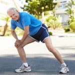 Older man warming up for a run.