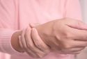 Woman holding painful wrist.