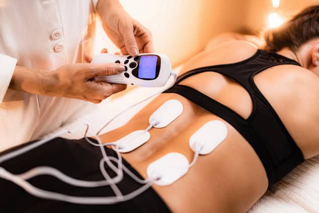 Lower back TENS therapy.