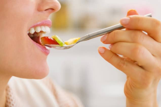 Closeup of a woman eating.