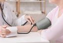 Measuring blood pressure in doctor's office.