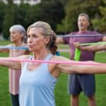 A group of older adults exercising outdoors.