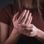 Woman with joint pain on her hands.